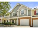 Inviting townhouse showcasing a private garage, a brick facade, and a well-maintained front yard at 2203 Hyssop Way, Buford, GA 30519
