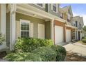 Attractive townhome featuring a one-car garage and a neatly landscaped front entrance at 2203 Hyssop Way, Buford, GA 30519
