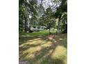 A cozy home surrounded by a lush, green yard and tall trees providing ample shade and privacy at 4688 Brice Dr, Union City, GA 30291