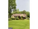 Sprawling home exterior with manicured lawn and mature trees at 7970 Berea Rd, Winston, GA 30187