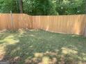 Fenced backyard with green grass providing privacy for outdoor activities at 3232 Deer Pause Ln, Decatur, GA 30034