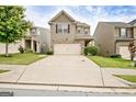 Inviting two-story home featuring stone accents, a two-car garage, and a long driveway at 529 Dasheill Ln, Atlanta, GA 30349