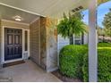 Welcoming front porch with stone detail, lush greenery, and inviting entryway showcasing curb appeal at 2866 Rosecommons Dr, Hampton, GA 30228
