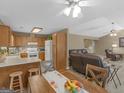 Inviting kitchen and open dining area, perfect for Gathering meals and entertaining with connecting living room at 2866 Rosecommons Dr, Hampton, GA 30228