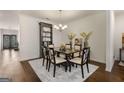 Elegant dining room features a stylish chandelier and neutral decor at 845 Graeme Dr, Mcdonough, GA 30252