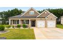 Beautiful brick home features a manicured lawn and attached two car garage at 845 Graeme Dr, Mcdonough, GA 30252