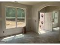 Bright living room featuring large windows and an arched doorway, awaiting its final touches at 5565 Hwy 155, Stockbridge, GA 30281