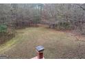 Large backyard area with a chimney in view, perfect for outdoor activities at 145 Mill Run, Fayetteville, GA 30214