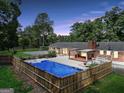 Aerial view of a home showcasing a large pool and a fenced backyard at 234 Crumbley Rd, Mcdonough, GA 30252