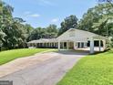 Charming home featuring manicured lawn, porte-cochère, and long driveway at 234 Crumbley Rd, Mcdonough, GA 30252
