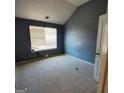 Cozy bedroom featuring soft carpet, a window for natural light, and blue painted walls at 7471 Garnet Dr, Jonesboro, GA 30236