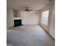 Spacious living room with plush carpeting, a fireplace, and a window offering natural light at 7471 Garnet Dr, Jonesboro, GA 30236