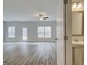 Spacious living room featuring new wood floors, modern ceiling fan, and backyard view at 4464 Eastbrook Pl # 56B, Snellville, GA 30039