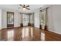 Bright living room with hardwood floors and large windows, complemented by neutral-toned curtains at 1278 Discover Green Lane Ln # 7, Mableton, GA 30126