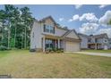Charming two-story home featuring a brick facade, neutral siding, and a two-car garage at 116 Sophie Cir, Locust Grove, GA 30248