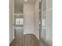 Inviting entryway with wood-look flooring and bright, neutral paint scheme leads into a living space at 4454 Eastbrook Pl # 57B, Snellville, GA 30039