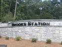 Brooks Station stone monument sign surrounded by lush trees and greenery at 1939 Van Allen Ct, Dacula, GA 30019