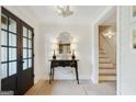 Elegant entryway featuring hardwood floors, shiplap walls, decorative mirror, and staircase access at 591 Clubwood Ct, Marietta, GA 30068
