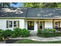 Inviting front porch featuring stone accents, a black double door, and manicured landscaping at 591 Clubwood Ct, Marietta, GA 30068