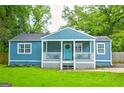 Charming blue cottage-style home with a welcoming front porch and lush green lawn at 1821 Clearwater, Marietta, GA 30067