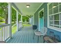 Charming front porch with seating, a vibrant blue painted floor, and white railing at 1821 Clearwater, Marietta, GA 30067