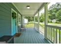 Inviting front porch with blue painted floor, white railing, and vibrant turquoise door at 1821 Clearwater, Marietta, GA 30067