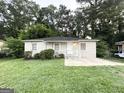 Cozy brick home with inviting front lawn surrounded by lush trees at 3645 Croft Nw Pl, Atlanta, GA 30331