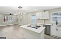 Open kitchen with quartz countertops, stainless steel appliances, and a large island at 1515 Jonesboro Se Rd, Atlanta, GA 30315