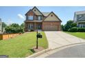 Beautiful two-story brick home with a well-manicured lawn and a two-car garage at 6665 Flagstone Ct # 918, Cumming, GA 30028