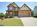 Inviting two-story brick home with a spacious front yard and attached two-car garage at 6665 Flagstone Ct # 918, Cumming, GA 30028