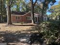 View of an attractive single story brick home shaded by mature trees at 718 N Hairston Rd, Stone Mountain, GA 30083