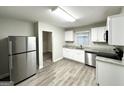 Modern kitchen with stainless steel appliances, white cabinets, granite countertops, and tile floors at 2644 Connally Dr, East Point, GA 30344