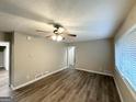 Spacious living room featuring hardwood floors, neutral paint, ceiling fan, and natural light at 2644 Connally Dr, East Point, GA 30344