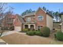 Lovely two-story brick home with landscaped yard and attached two-car garage at 2126 Roberts View Trl, Buford, GA 30519