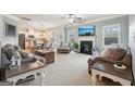 Bright living room featuring a fireplace, large windows, and an open view of the kitchen at 2126 Roberts View Trl, Buford, GA 30519