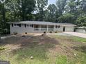 Ranch home with painted brick exterior, covered porch, and level front yard at 4329 Parkview Dr, Lithia Springs, GA 30122