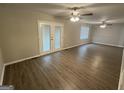Spacious living room featuring wood-look flooring and french doors to backyard at 4329 Parkview Dr, Lithia Springs, GA 30122