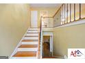 Inviting staircase with wood and iron railing leading to upper and lower levels at 2101 Newgate, Decatur, GA 30035