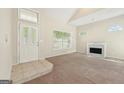 Inviting living room with a fireplace, large windows, and neutral carpet at 686 Shore Ln, Lithonia, GA 30058