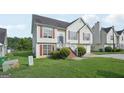 Two-story home featuring light siding, red shutters, an attached garage, and a spacious front yard at 4738 Golod Way, Lithonia, GA 30038