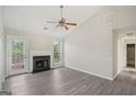 Bright living room with fireplace, vaulted ceilings, a ceiling fan, and neutral paint tones at 4738 Golod Way, Lithonia, GA 30038