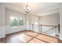 Elegant dining room with hardwood floors, large window, and classic wainscoting at 6005 Crowley Dr, Douglasville, GA 30135