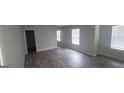 Bright living room with hardwood floors and multiple windows, offering lots of natural light at 3484 Enterkin Ln, South Fulton, GA 30349