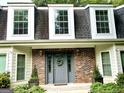 Close-up view of the front entrance with brick accents and a decorative door at 308 Larkspur Turn, Peachtree City, GA 30269