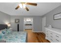 Bright bedroom with hardwood floors and an en suite bathroom with granite countertops at 308 Larkspur Turn, Peachtree City, GA 30269