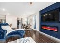 Inviting living room flowing into the dining area, showcasing a decorative fireplace and hardwood floors at 12167 Conrad Cir, Hampton, GA 30228