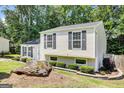 Pleasant home with attractive landscaping and a unique boulder feature enhancing the outdoor aesthetics at 183 Wynnmeade, Peachtree City, GA 30269