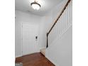 Bright entryway with hardwood floors, staircase, and a traditional white front door at 505 Mariposa Ln, Mcdonough, GA 30253