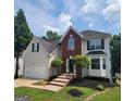 Charming two-story home boasts a manicured lawn, brick accents, and an attached two-car garage at 2587 Mead Ct, Jonesboro, GA 30236