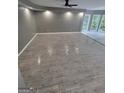 Bright living room featuring recessed lighting, large windows, and tile wood-patterned floors at 2587 Mead Ct, Jonesboro, GA 30236